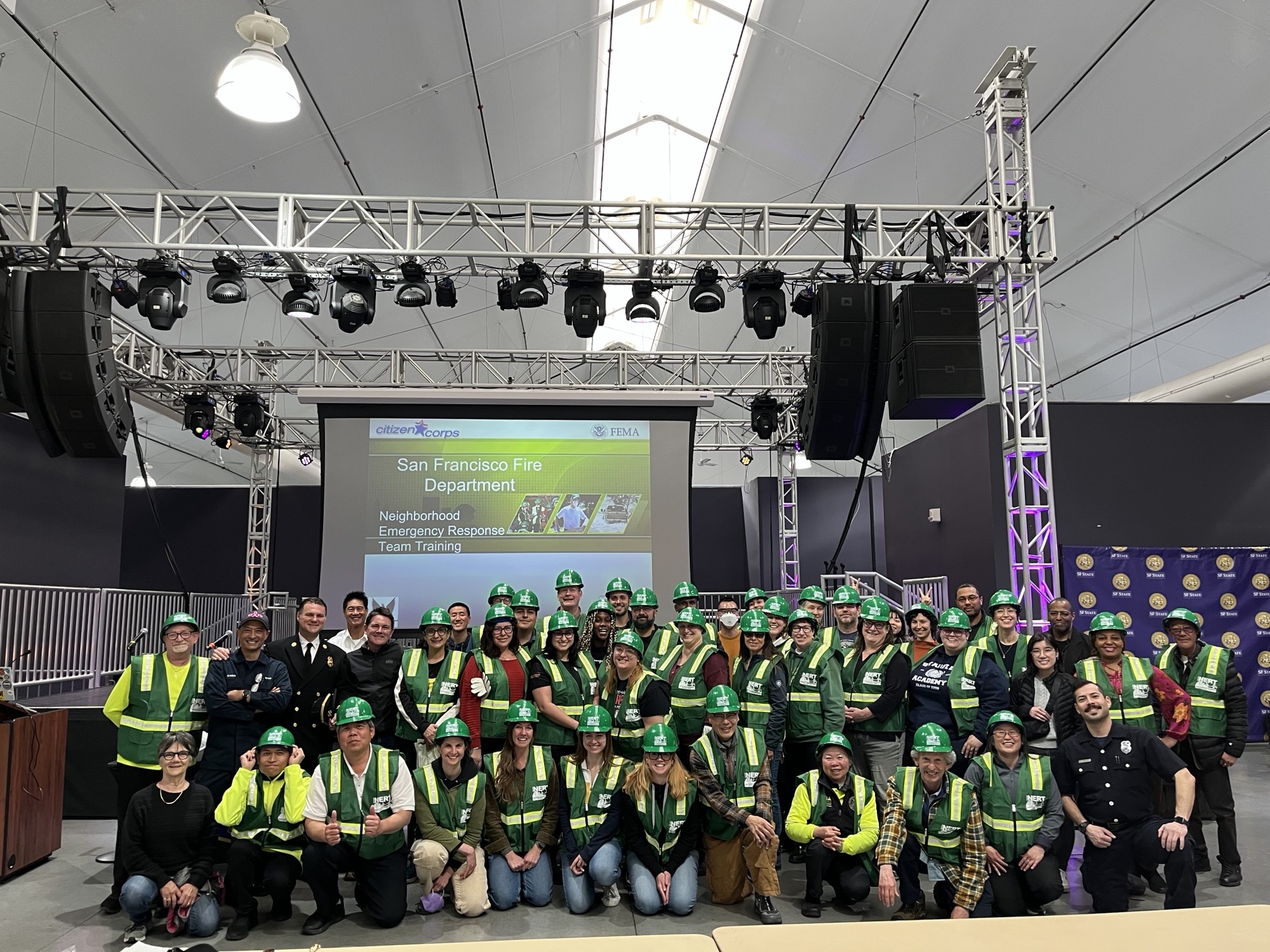 60 Participants from NERT 2025 at SF State face the camera in their new vests and hard hats. 