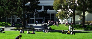 Picture of students sitting down and walking around the quad at San Francisco State University